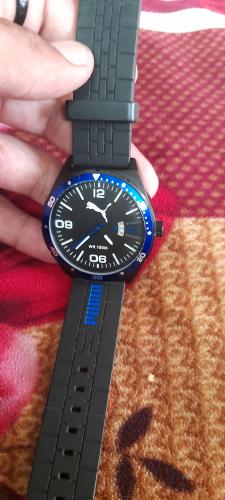 The watch shown is a Puma Day Essential model, specifically